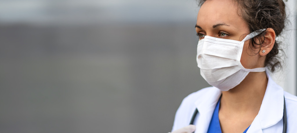 Female doctor wearing face protection during COVID-19 virus pandemic.