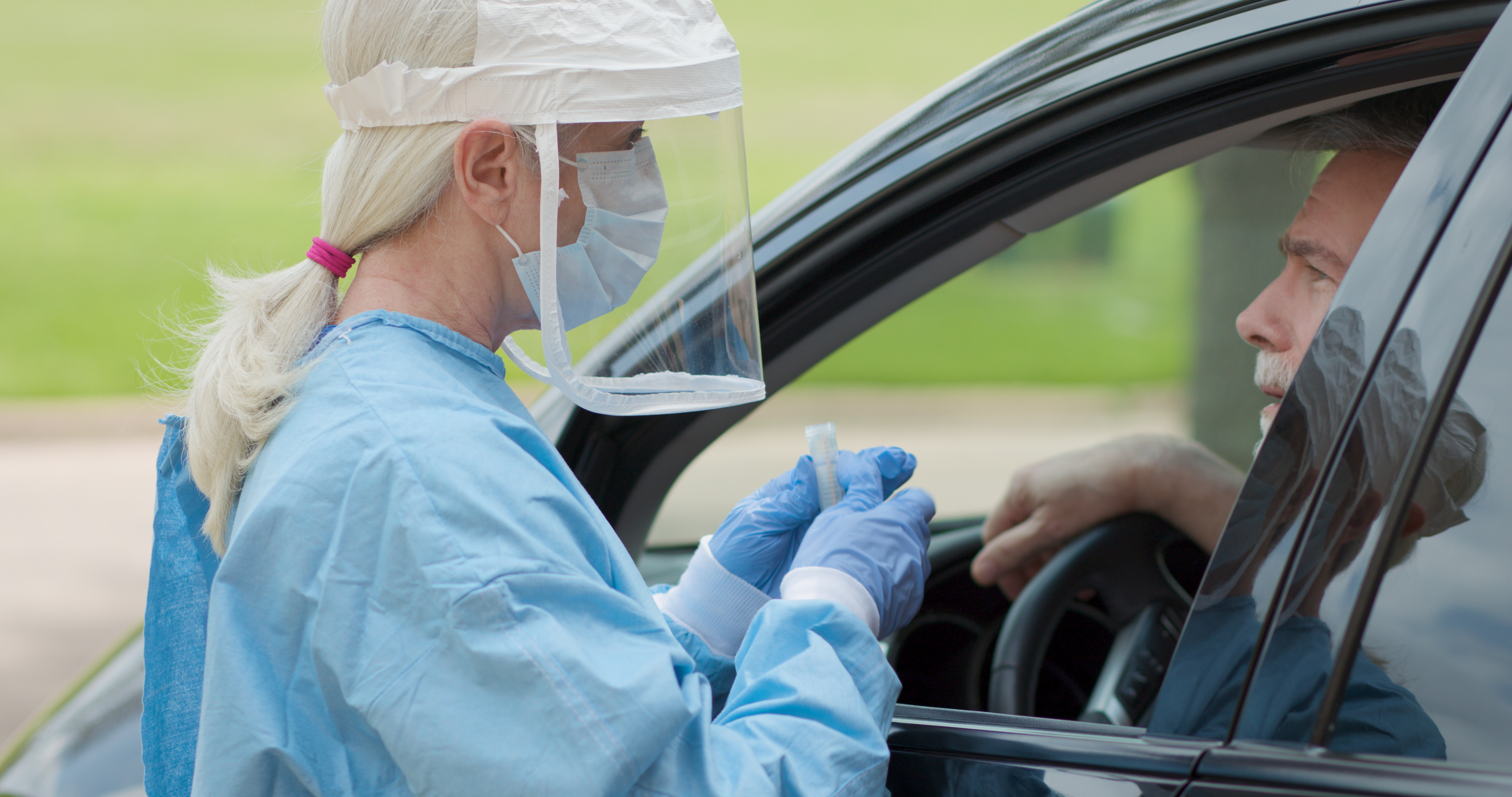 Healthcare Worker in PPE testing for COVID-19 virus drive-thru
