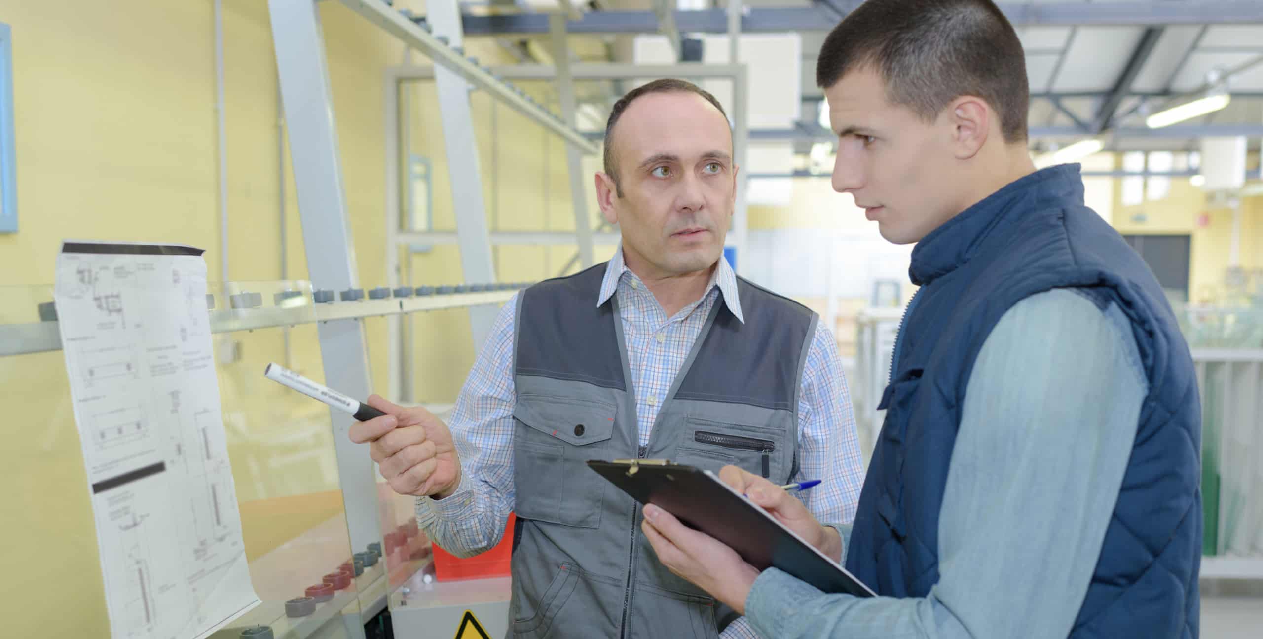 Man showing instructions chart to trainee