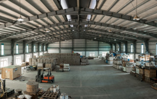 A wide shot of a warehouse with forklifts